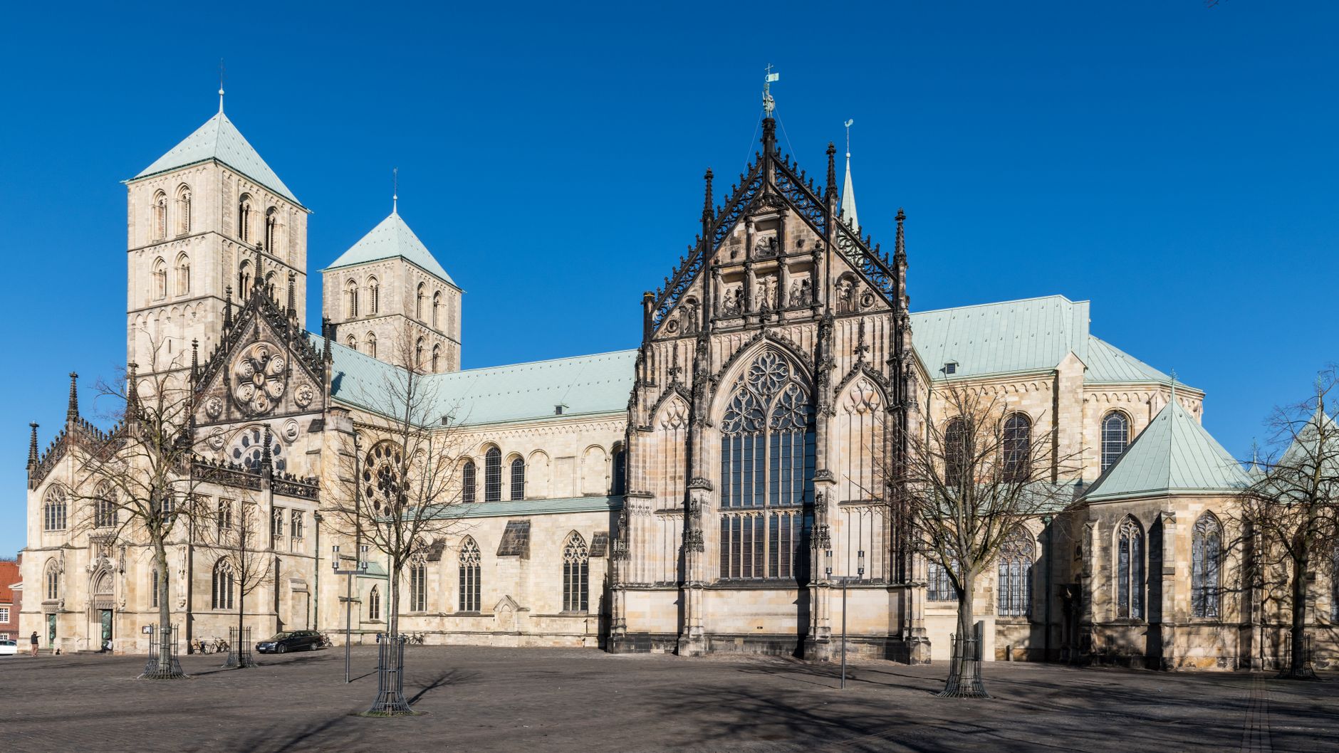 Front view of the historic St. Paulus Cathedral under clear blue skies in Münster, Germany.