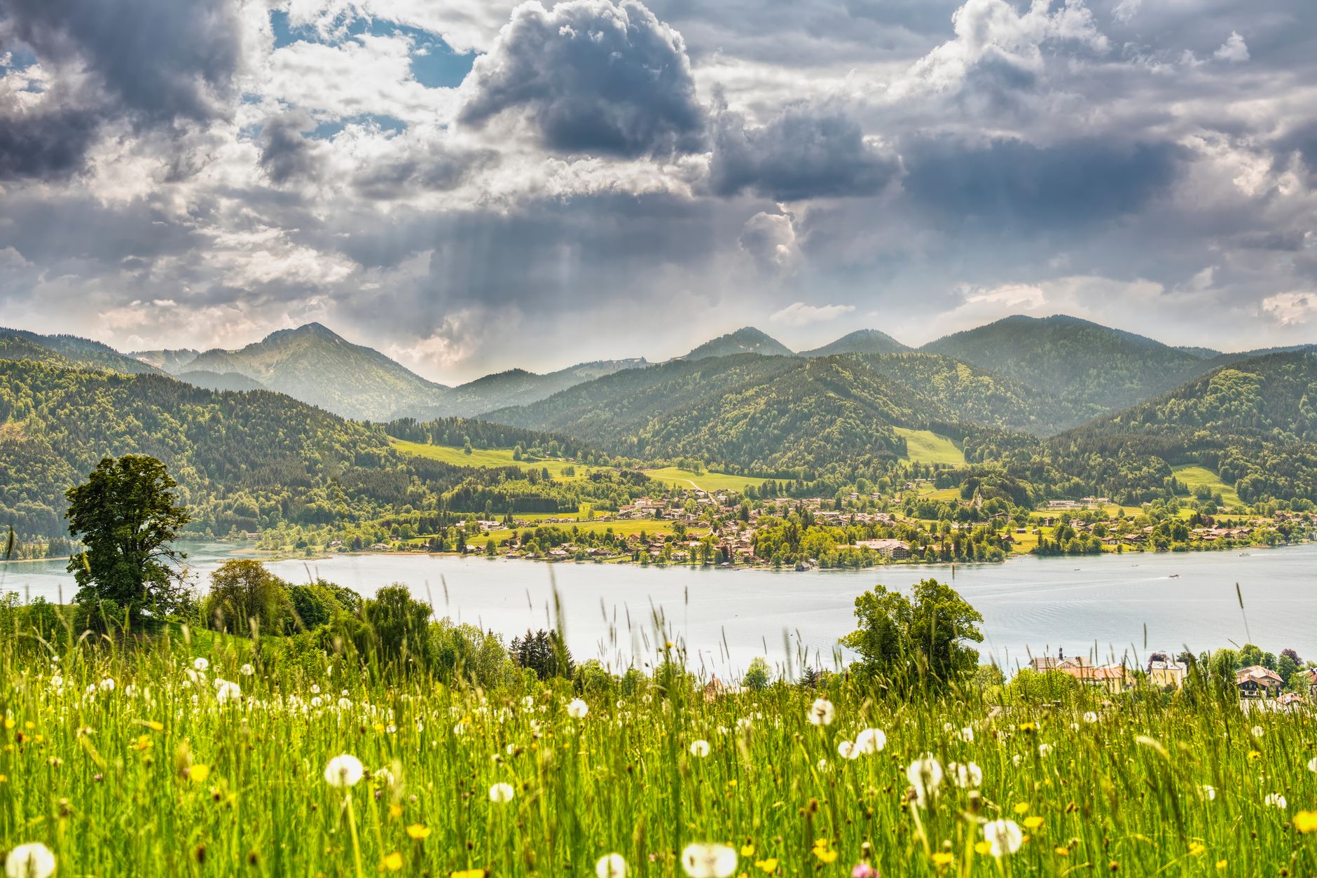 Breathtaking panorama of Tegernsee Lake surrounded by the lush Bavarian Alps in summer.