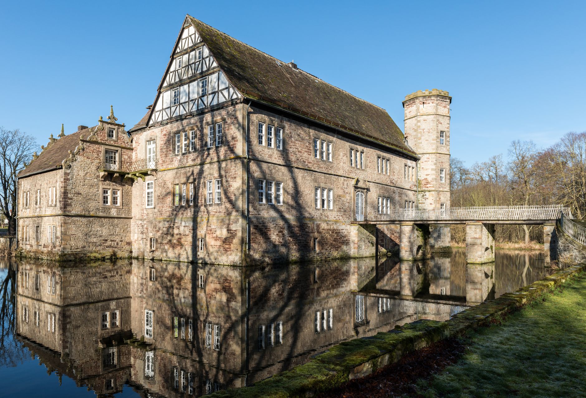 Stunning medieval castle reflection in Willebadessen, Germany, showcasing historic architecture.